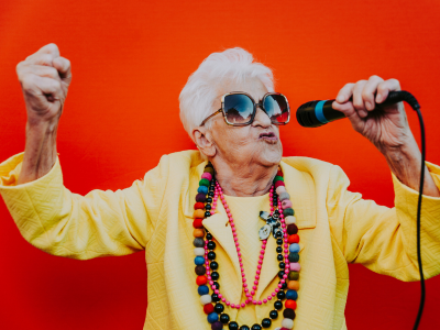 Image of an elderly woman singing karaoke