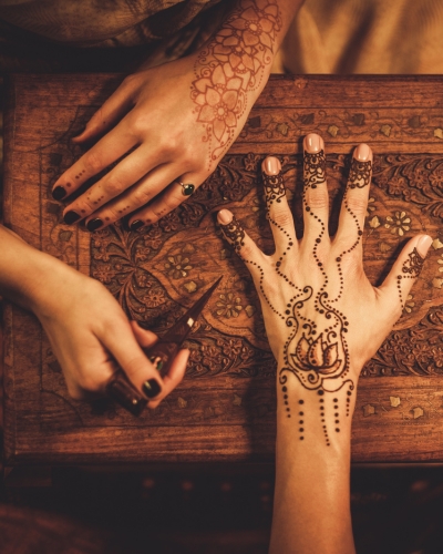 Henna being put onto hands.