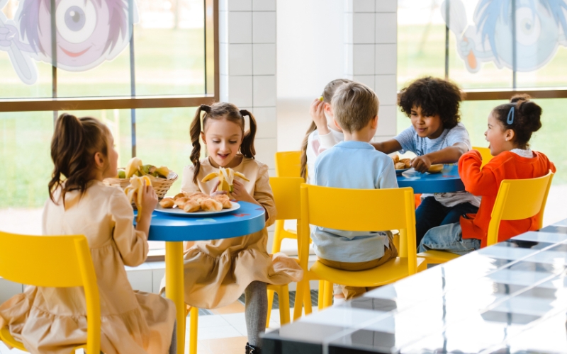 Group of kids sitting down doing an activity.