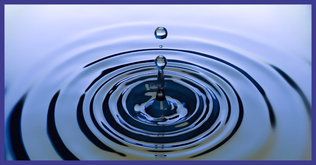 A close up of ripples in water after something was dropped in the water.