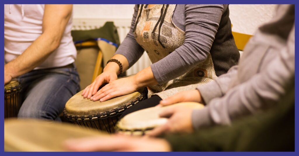 People playing drums with their hands.